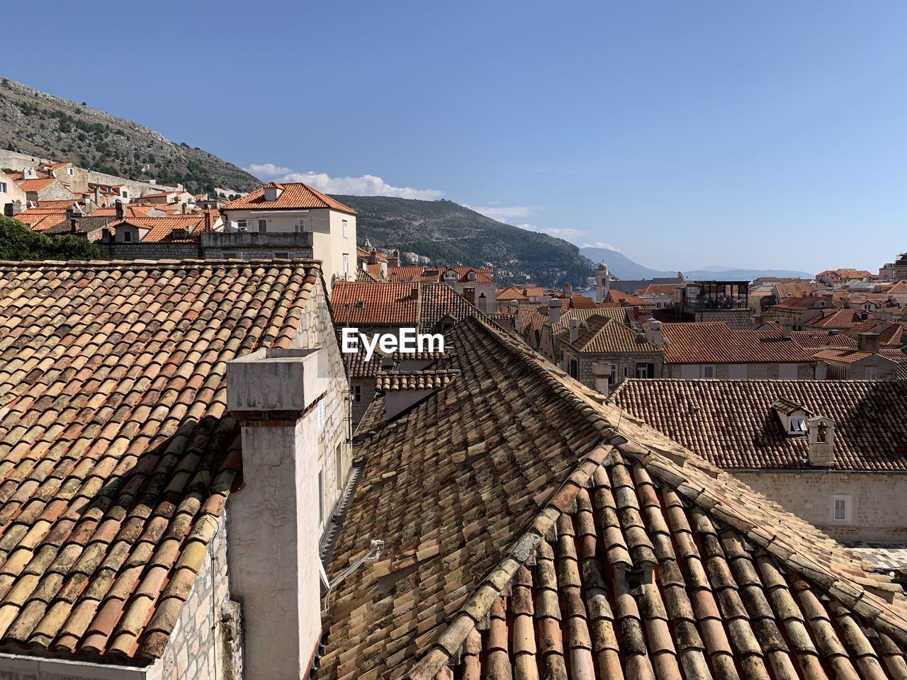 Buildings in city against clear blue sky