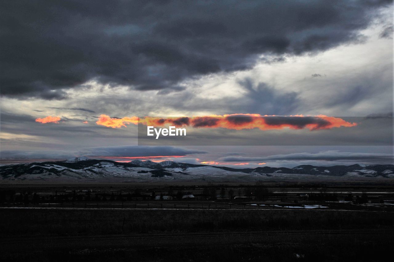 SCENIC VIEW OF DRAMATIC SKY DURING SUNSET