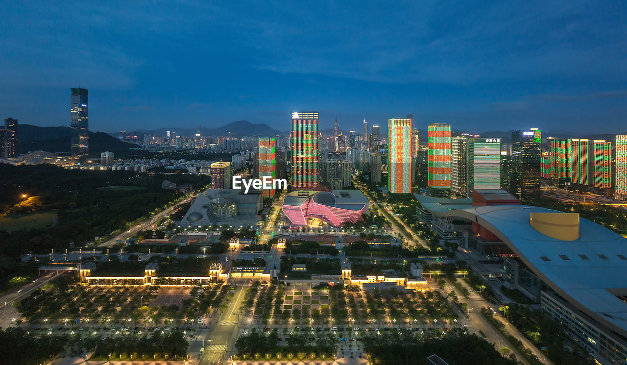 High angle view of illuminated buildings against sky at night