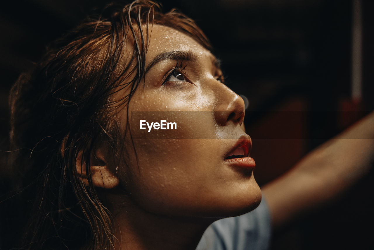 Face of female athlete with sweat while working out at gym