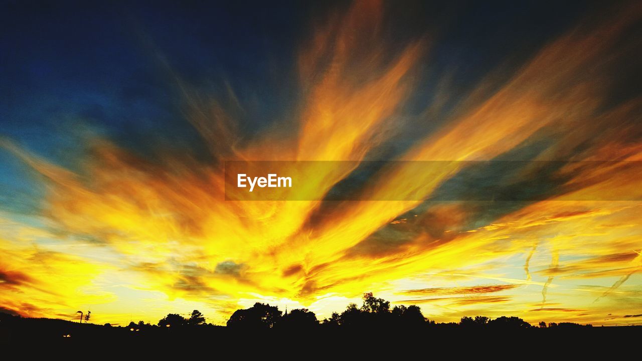 Low angle view of dramatic sky during sunset