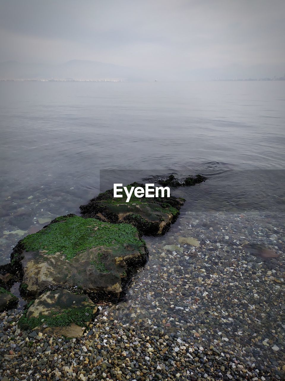 High angle view of rocks on beach against sky