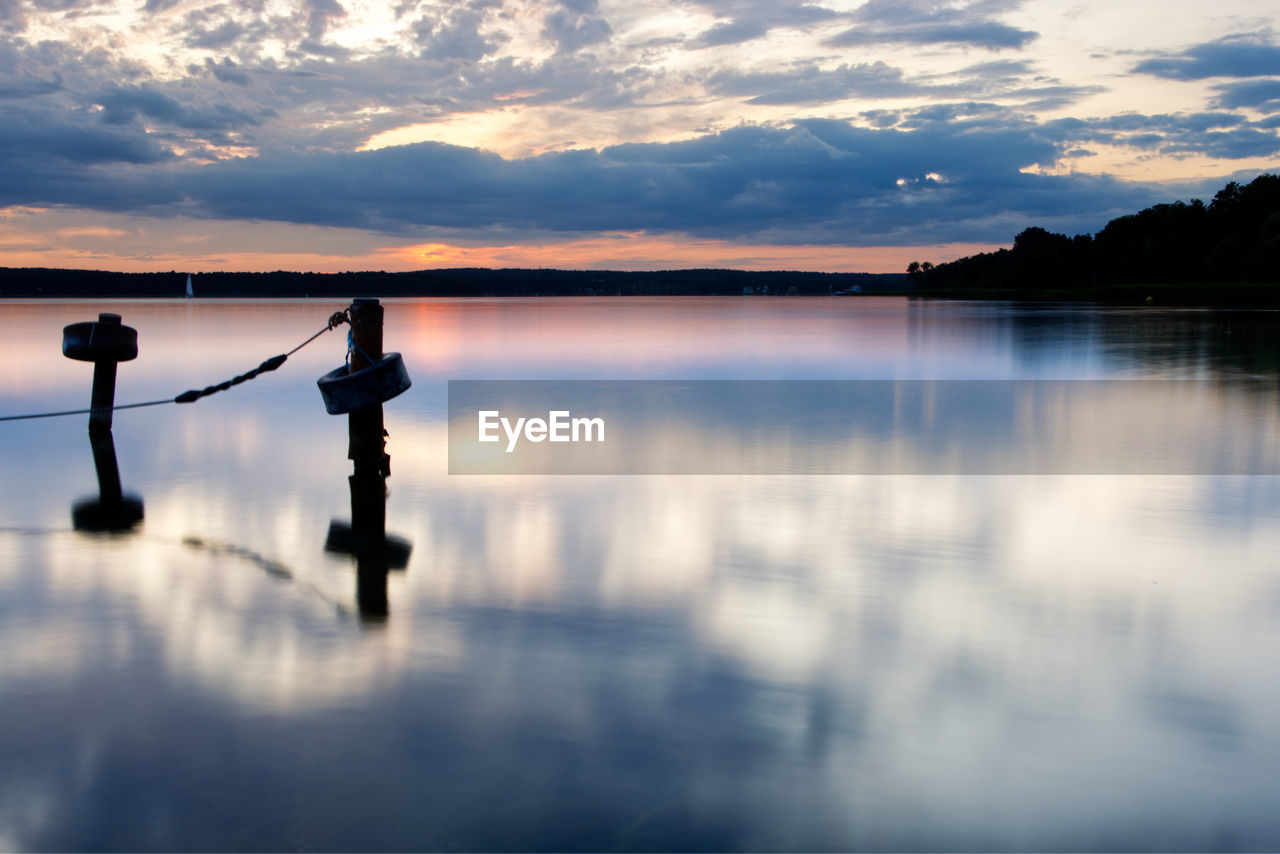 SCENIC VIEW OF LAKE AGAINST ORANGE SKY