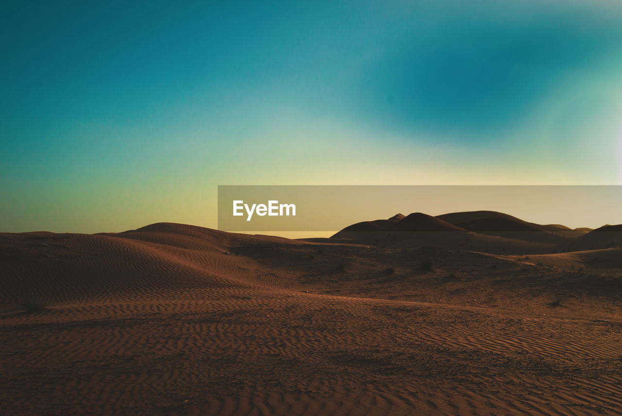 SCENIC VIEW OF ARID LANDSCAPE AGAINST CLEAR SKY