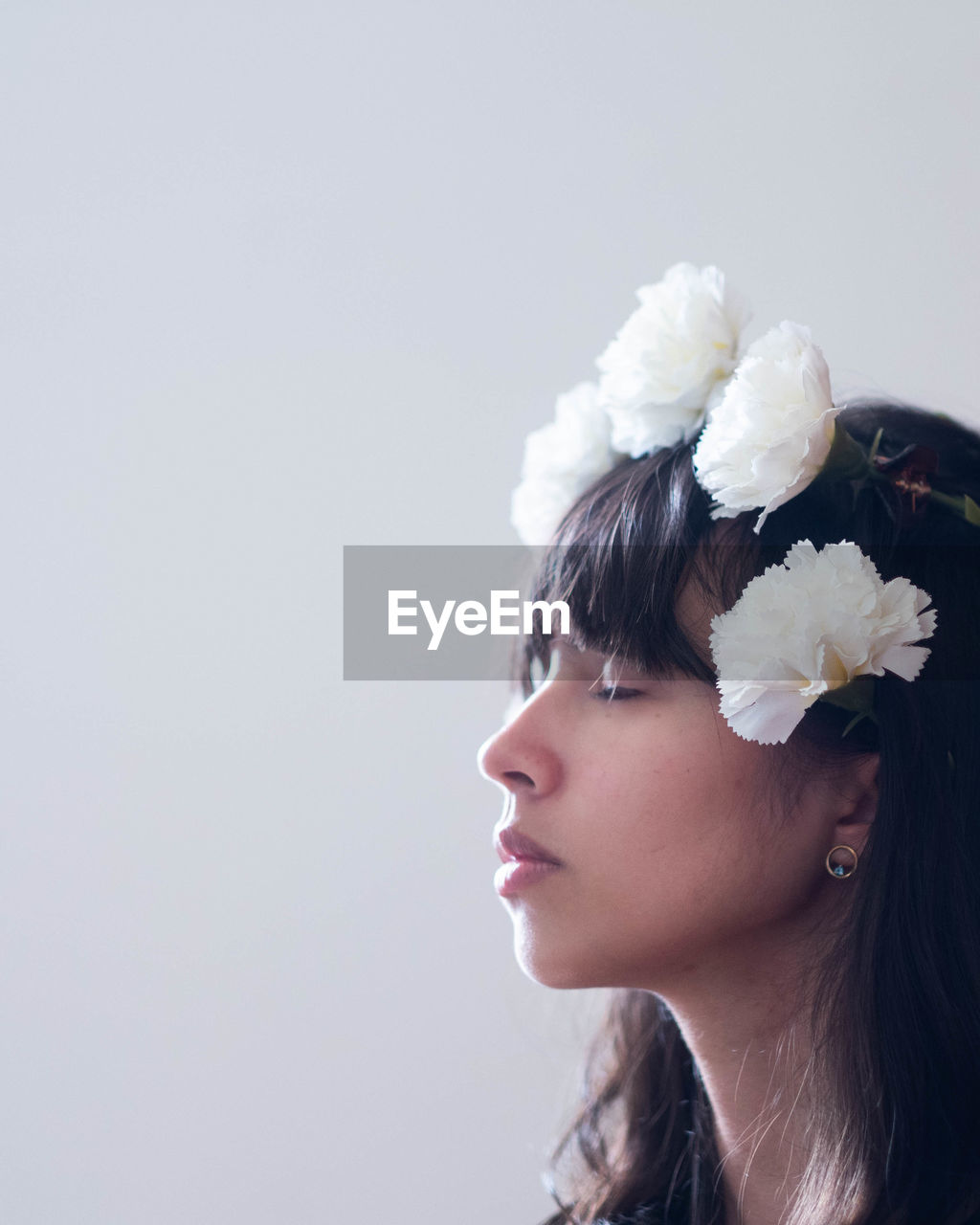 Woman with flowers against white background