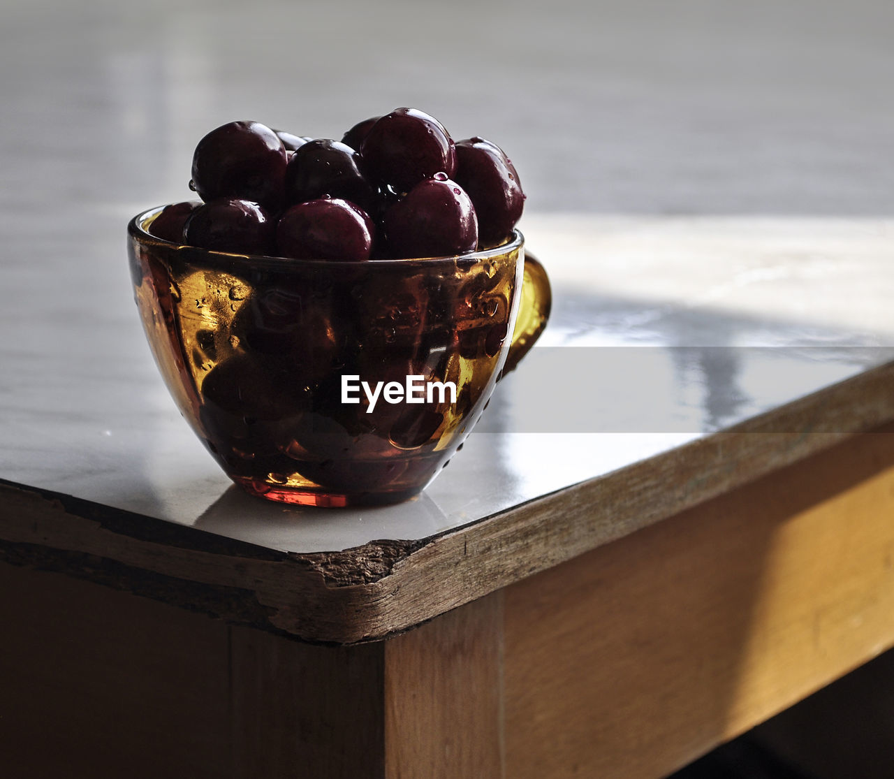 Close-up of fresh fruits in cup on table