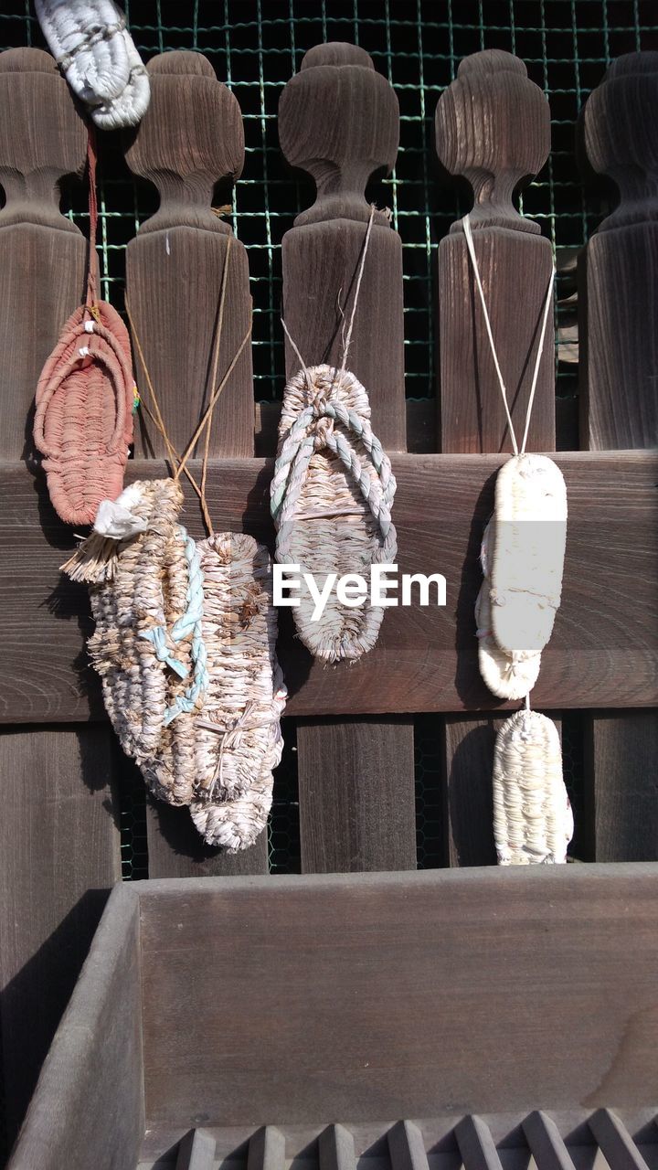 Close-up of flip-flops hanging outside temple