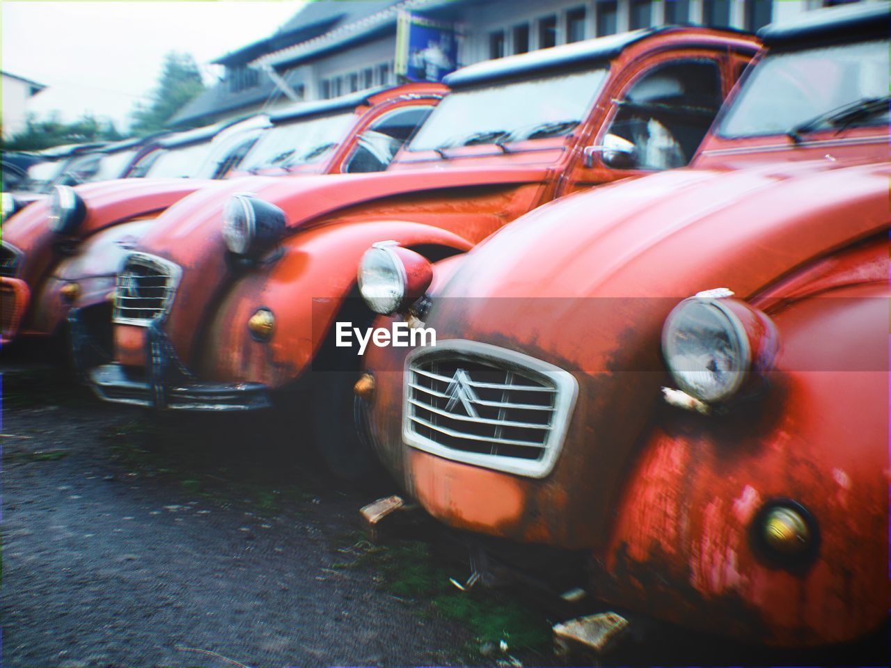 CLOSE-UP OF RED VINTAGE CAR ON MOTORCYCLE