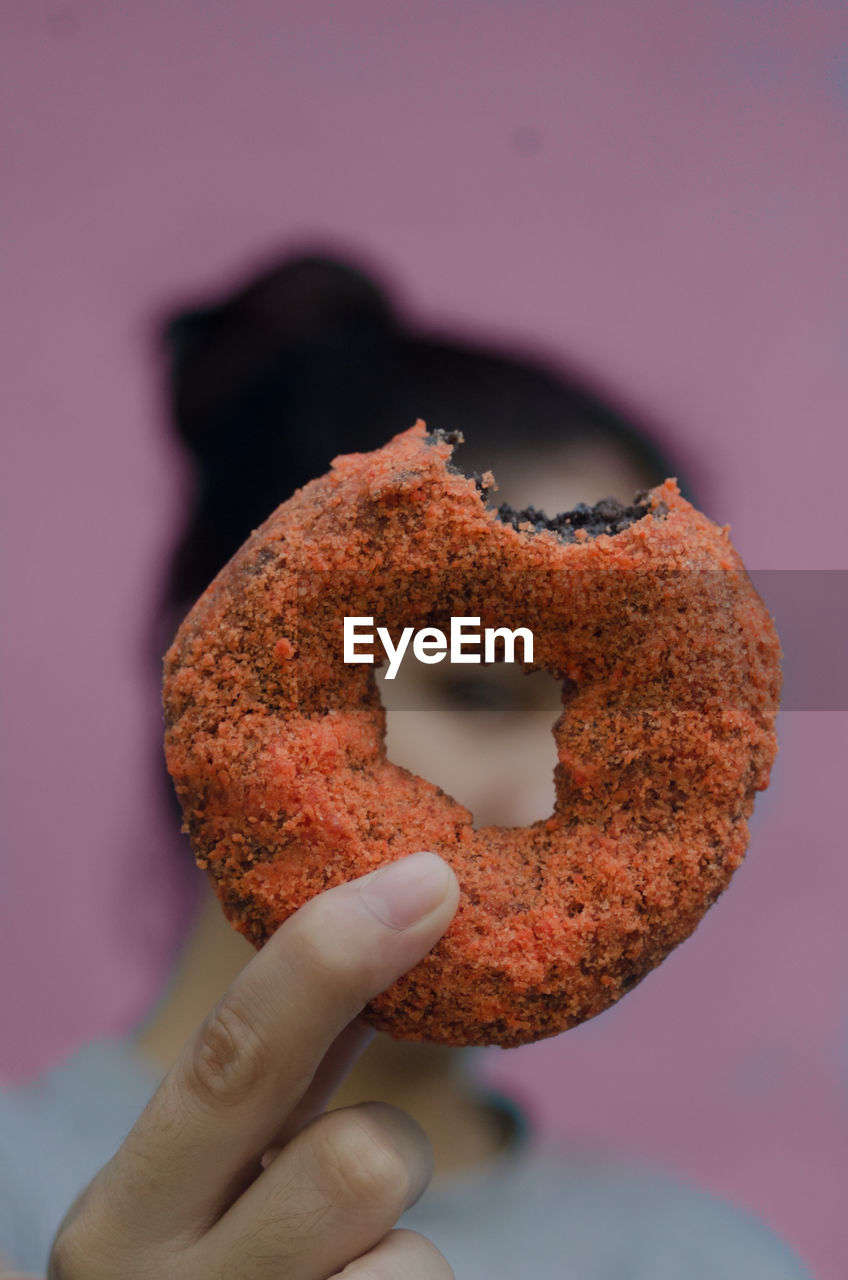 Close-up of woman holding donut