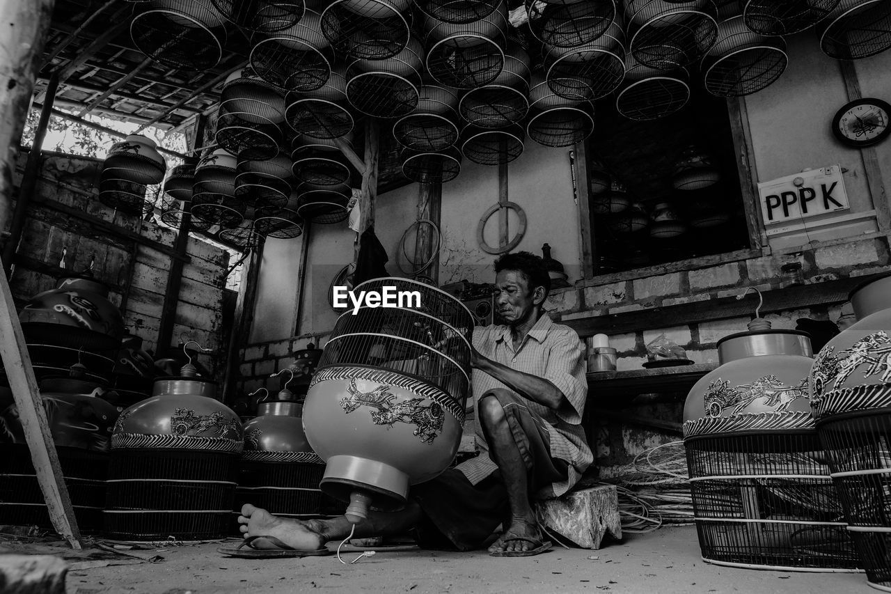 Low angle view of man making equipment in workshop