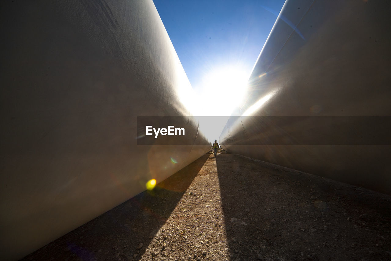 Person walks between blades at wind farm in ft. davis, texas person