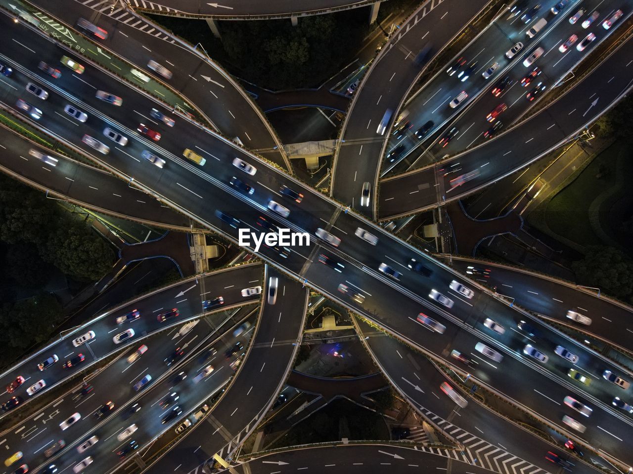 High drone view of illuminated road with traffic jam at elevated yan'an intersection in shanghai.