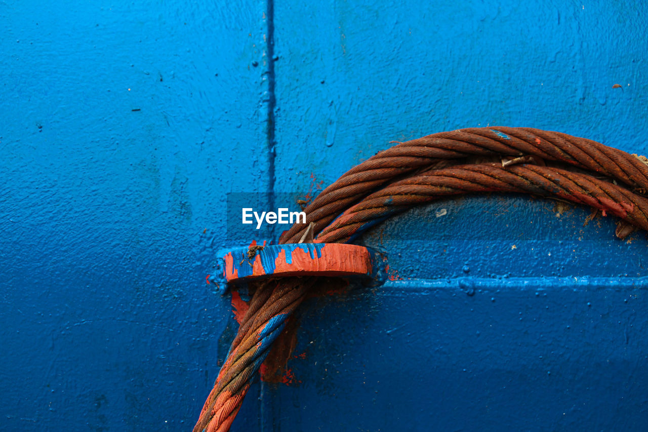 Close-up of rope tied on metal door