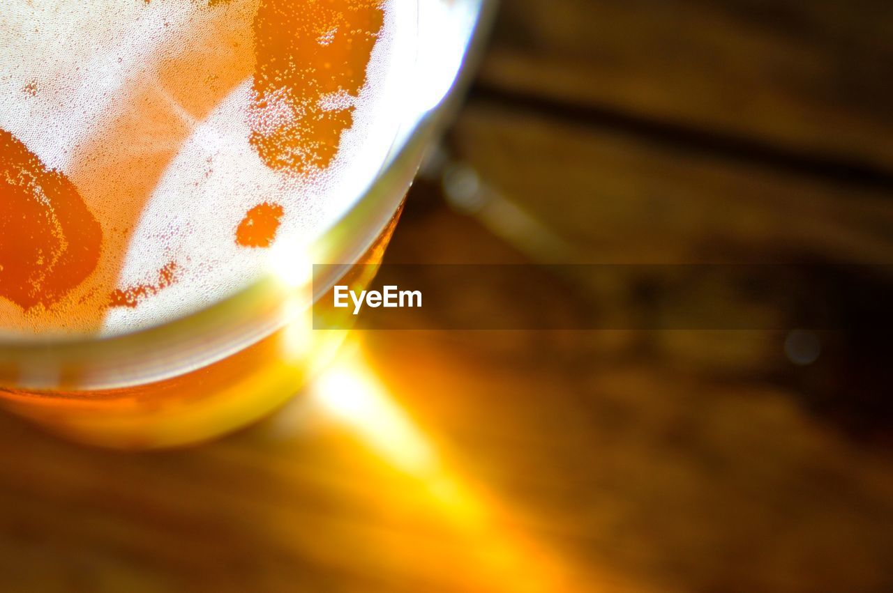 Cropped image of beer glass on table
