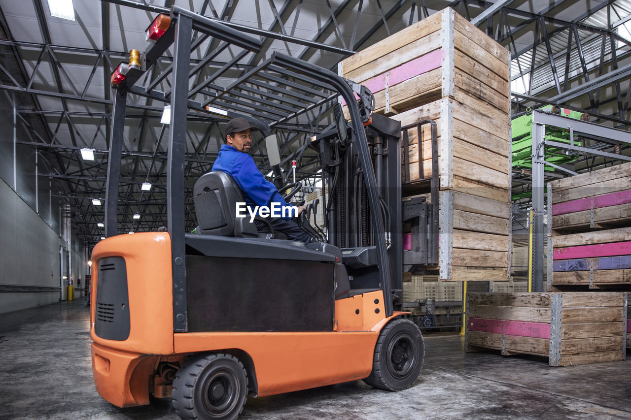 Man on forklift in factory hall