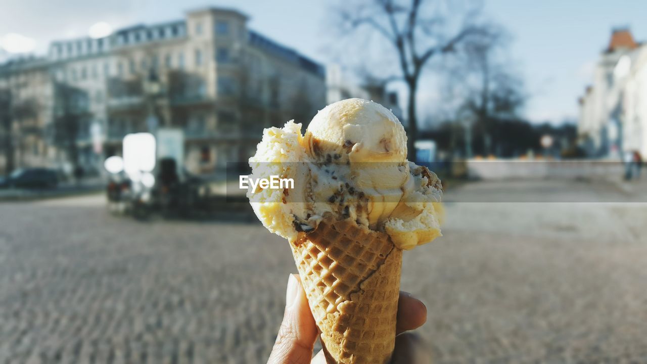 Close-up of hand holding ice cream cone