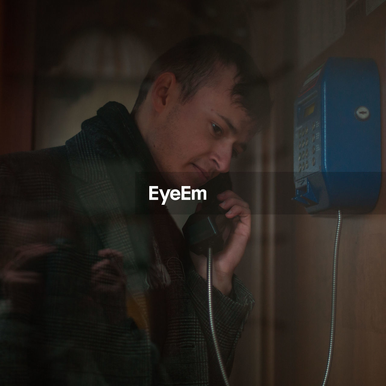 Young man talking on telephone