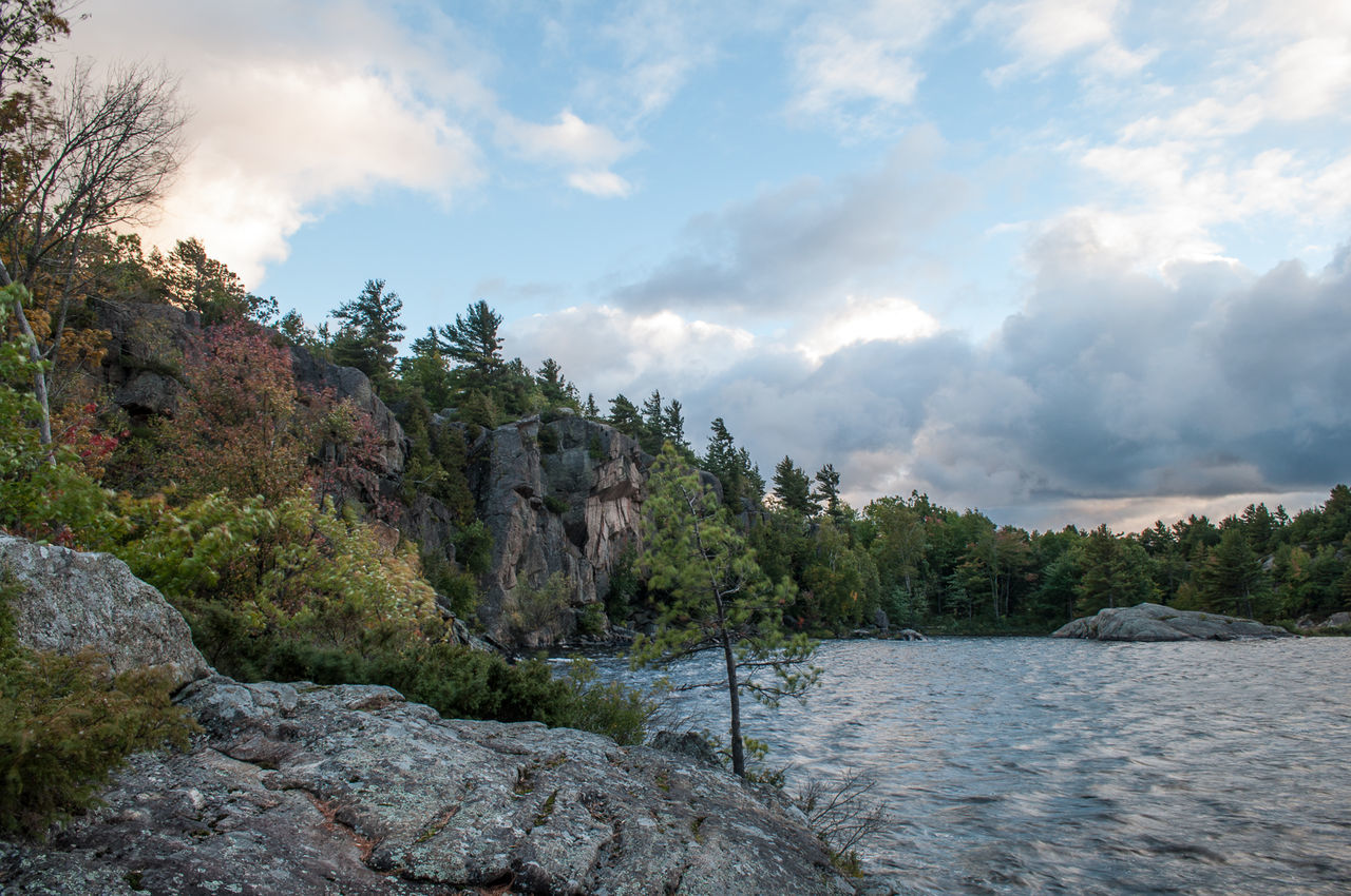 Scenic view of calm lake against cloudy sky