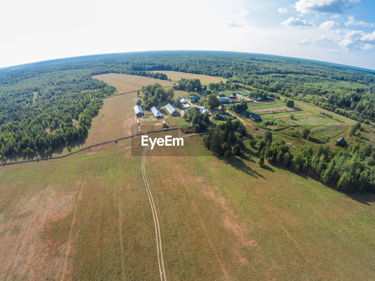 AERIAL VIEW OF AGRICULTURAL LANDSCAPE AGAINST SKY