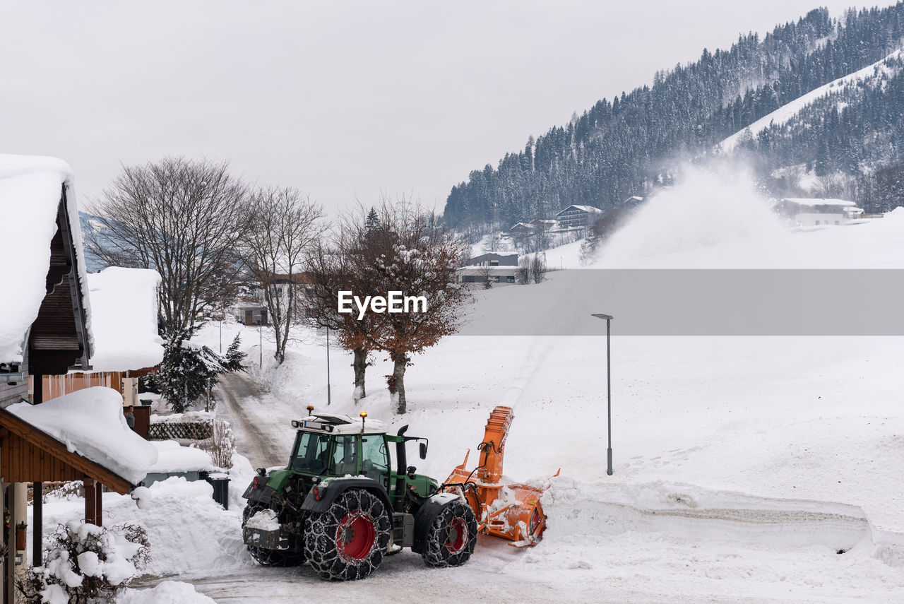 SNOW COVERED LAND AGAINST SKY