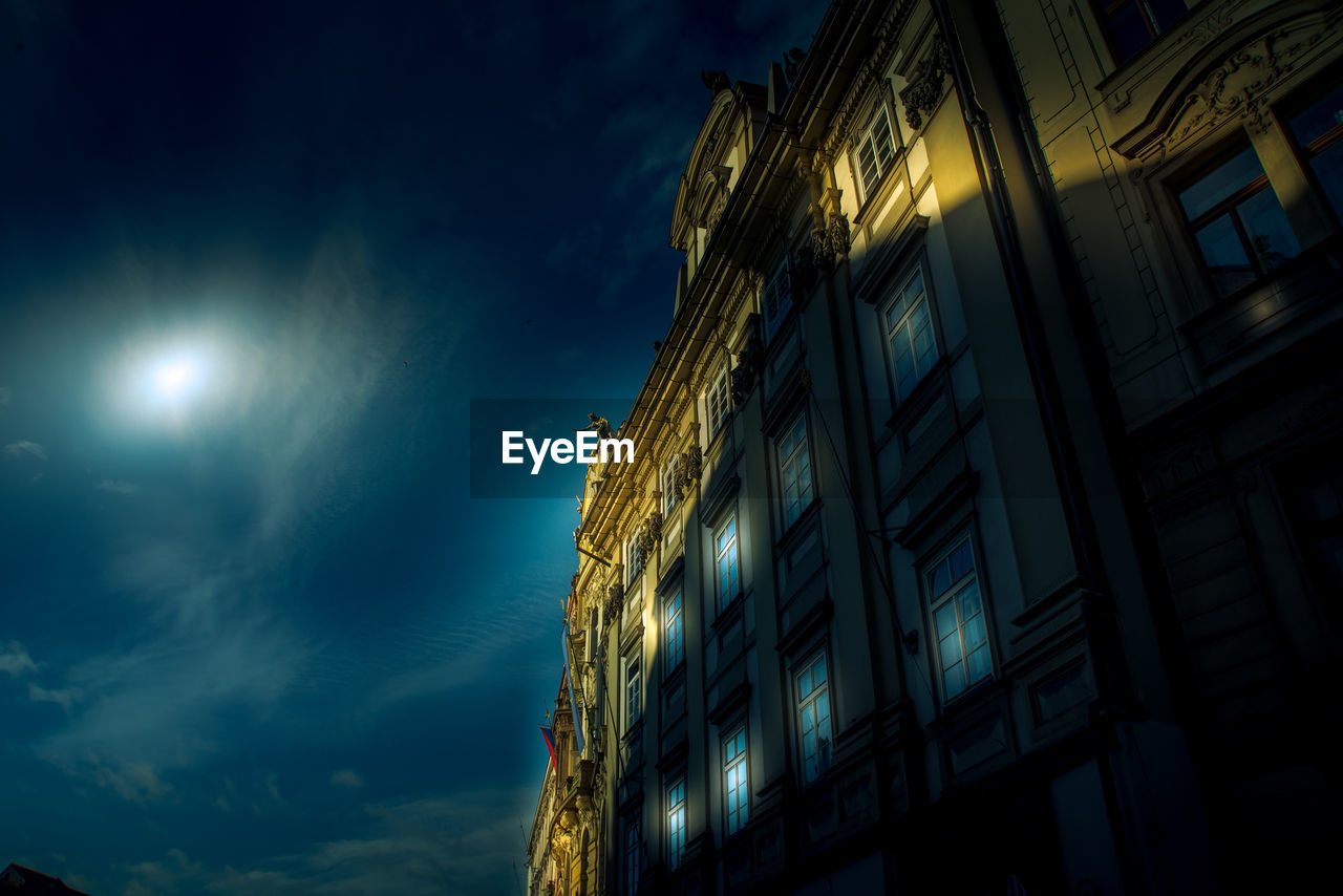 Low angle view of illuminated buildings against sky at night