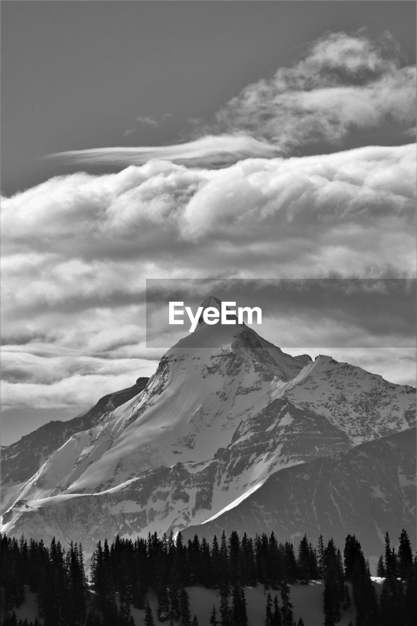 mountain, black and white, scenics - nature, cloud, beauty in nature, sky, snow, environment, landscape, cold temperature, monochrome photography, winter, snowcapped mountain, mountain range, nature, monochrome, tree, travel destinations, tranquil scene, land, tranquility, non-urban scene, travel, plant, tourism, outdoors, no people, mountain peak, day, forest, coniferous tree, idyllic