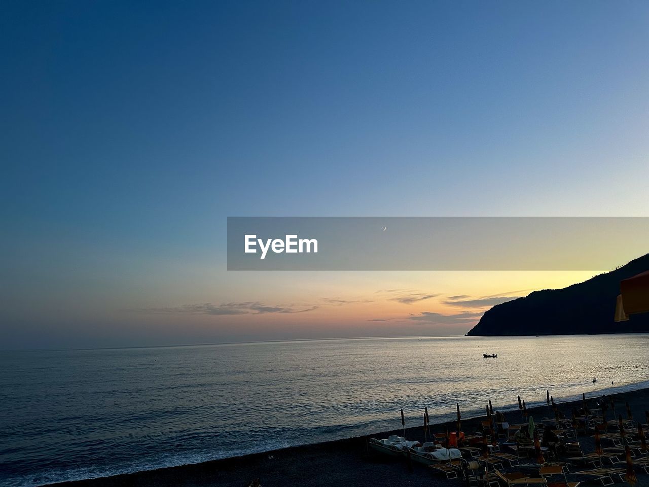 sky, sea, water, horizon, ocean, sunset, scenics - nature, beauty in nature, dusk, nature, beach, land, horizon over water, coast, evening, tranquility, tranquil scene, cloud, blue, architecture, reflection, no people, travel destinations, shore, travel, wave, sunlight, transportation, clear sky, outdoors, idyllic, seascape, body of water, built structure, bay, holiday, vacation, copy space, trip, sun, nautical vessel, tourism, coastline, building exterior