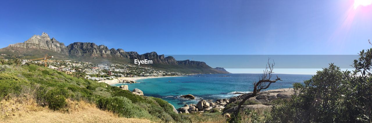 Panoramic shot of sea against clear blue sky