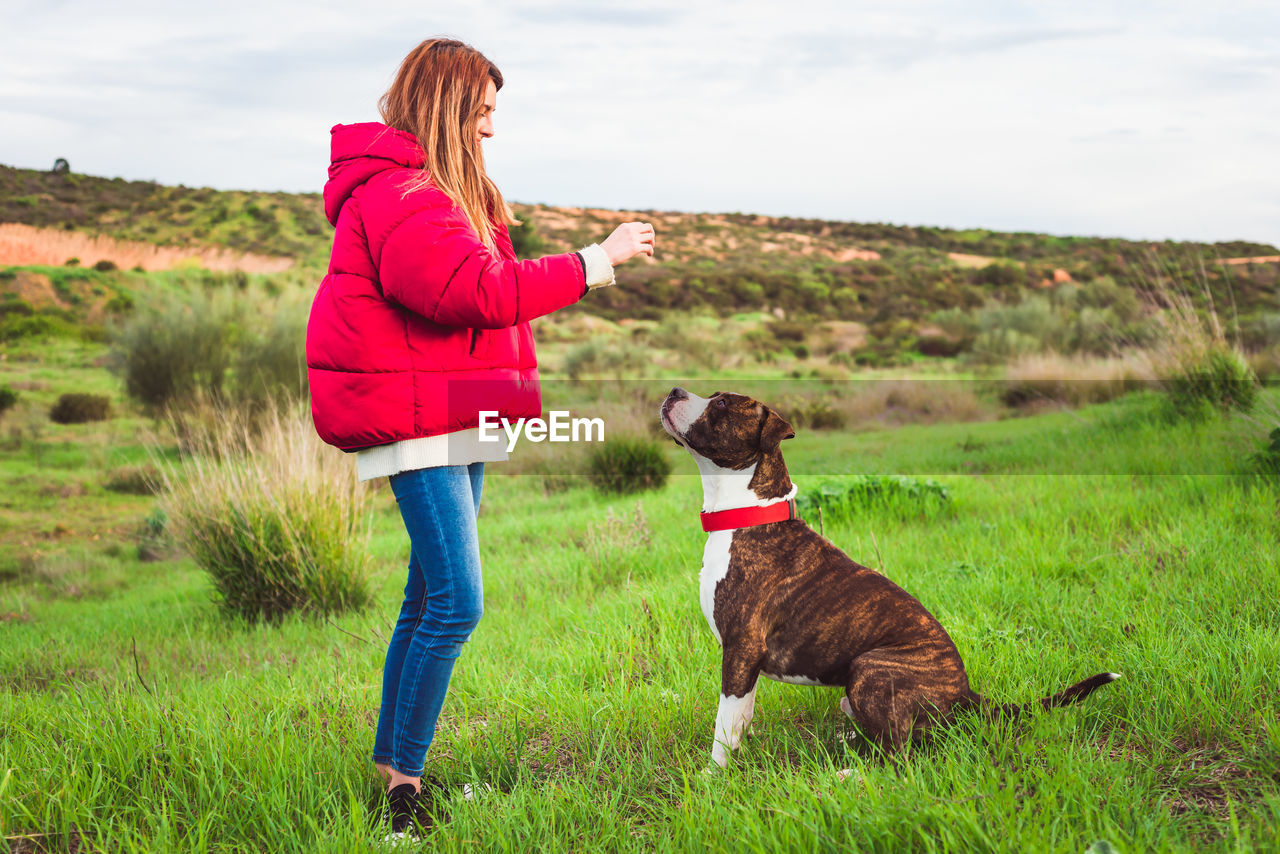 Woman with dog on grass