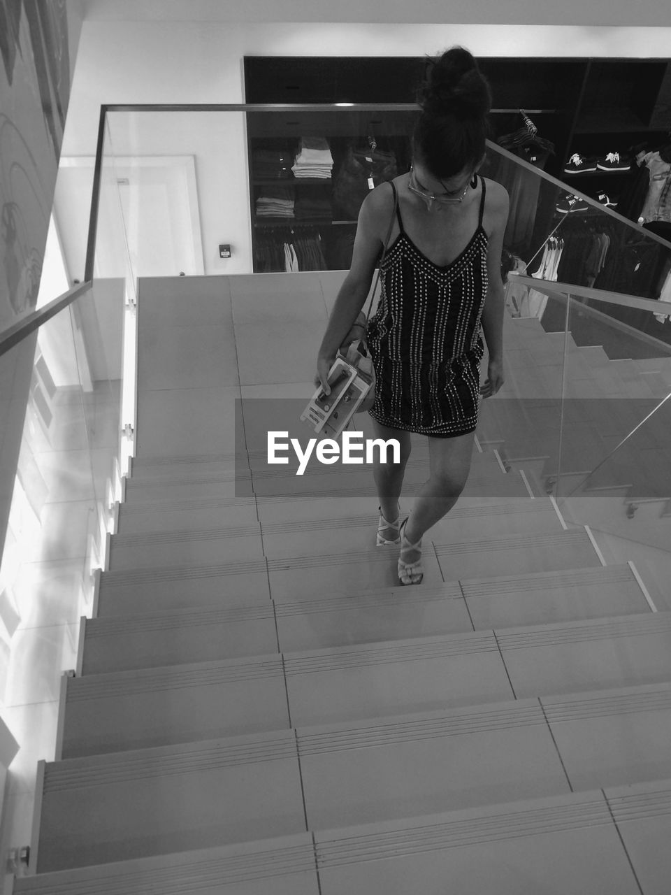 High angle view of woman moving up on steps at atrium mall
