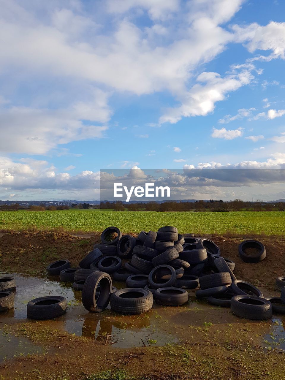 STACK OF HAY BALES ON FIELD