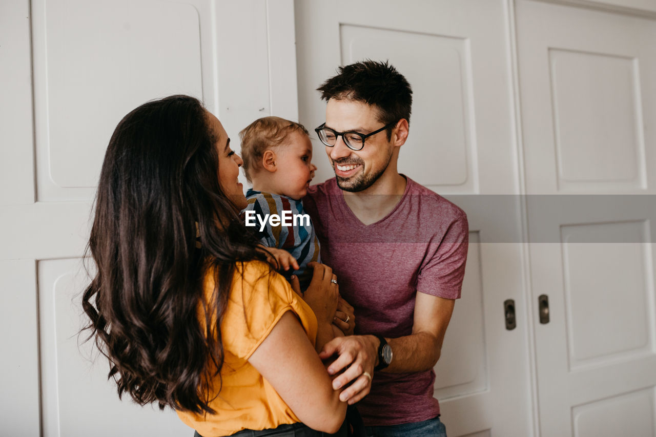 Happy family by door at home