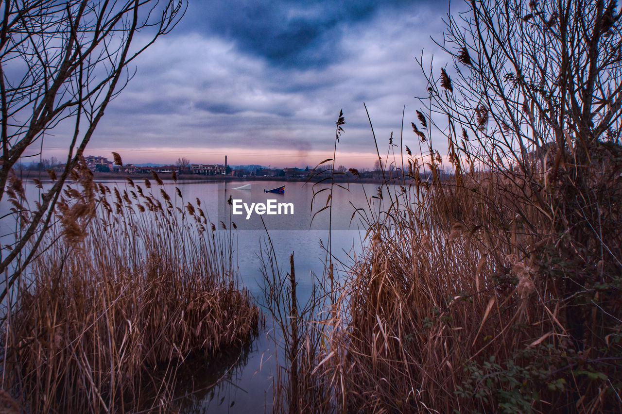 Scenic view of lake against sky during sunset