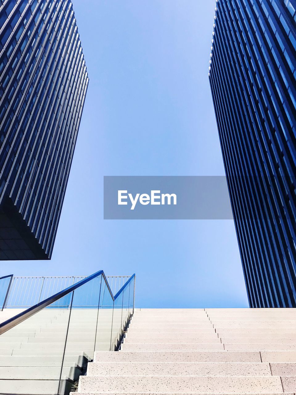 Low angle view of buildings against clear blue sky