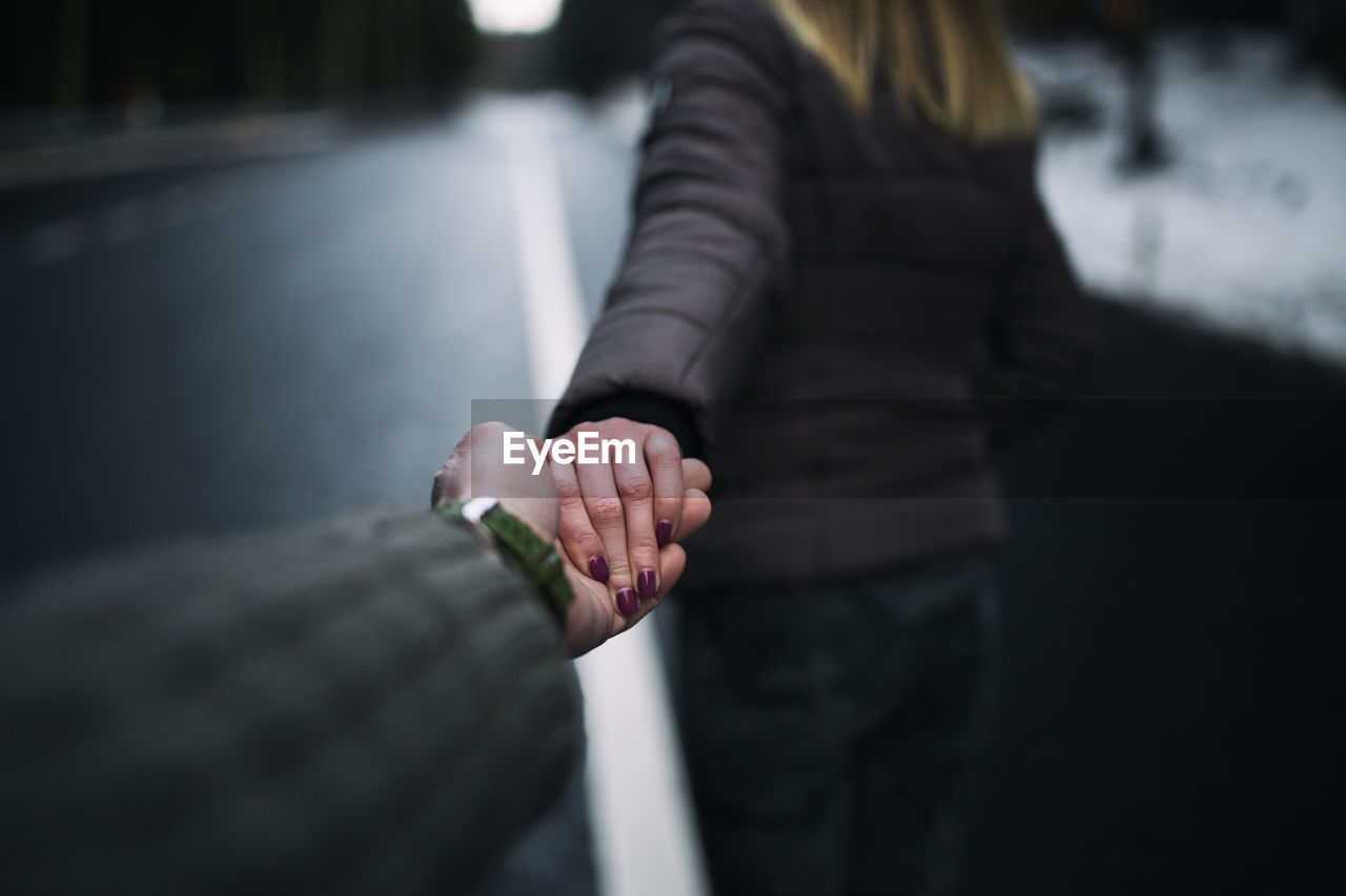 Close-up of couple holding hands