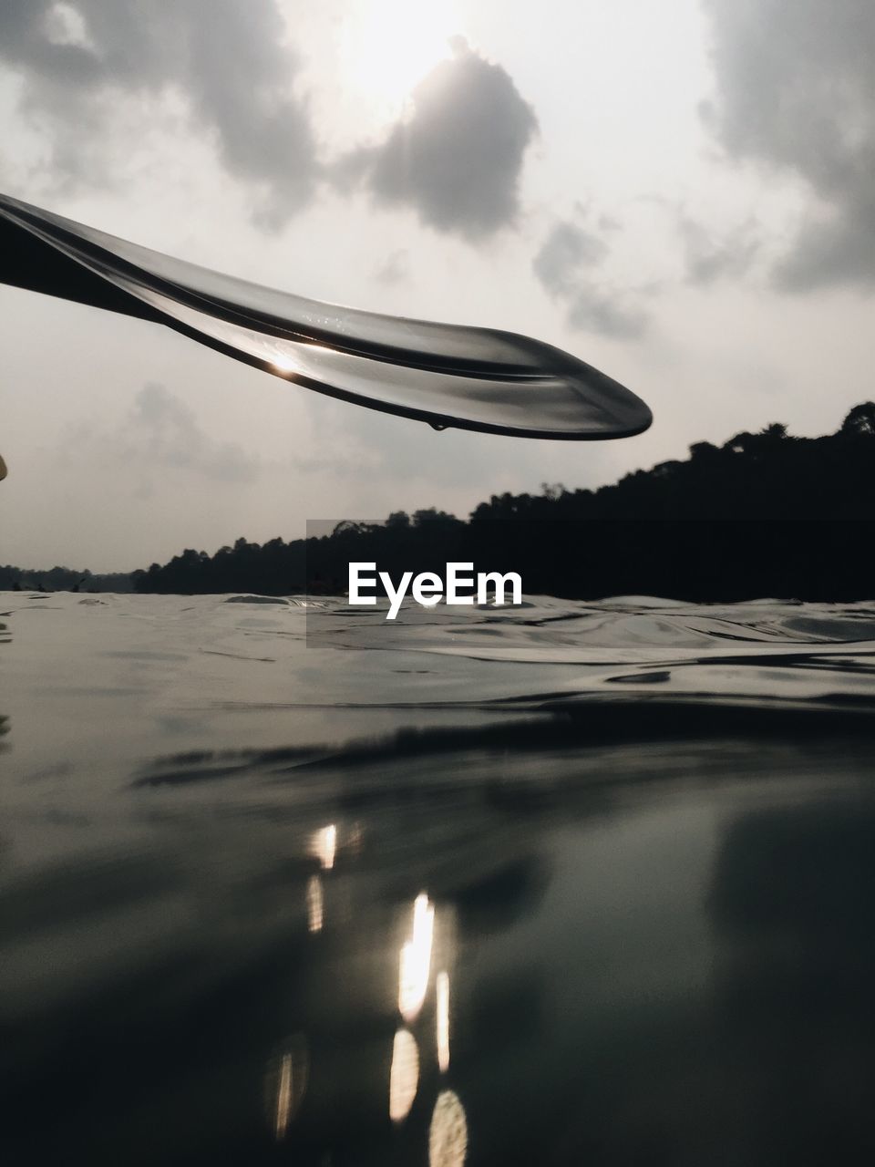 Low angle view of oar at river against sky