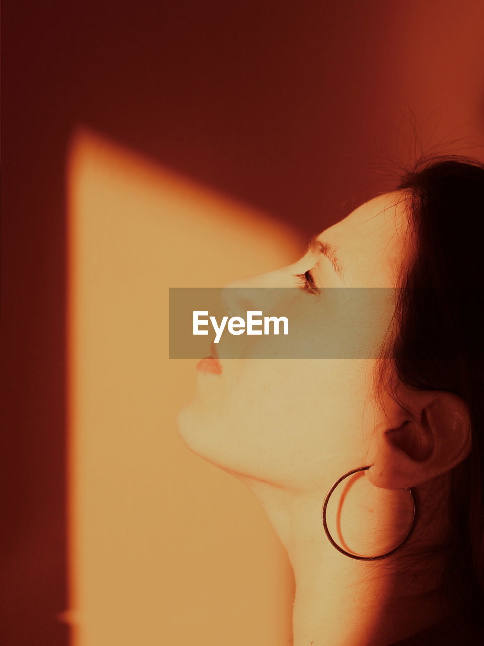 Close-up of young woman against wall at home