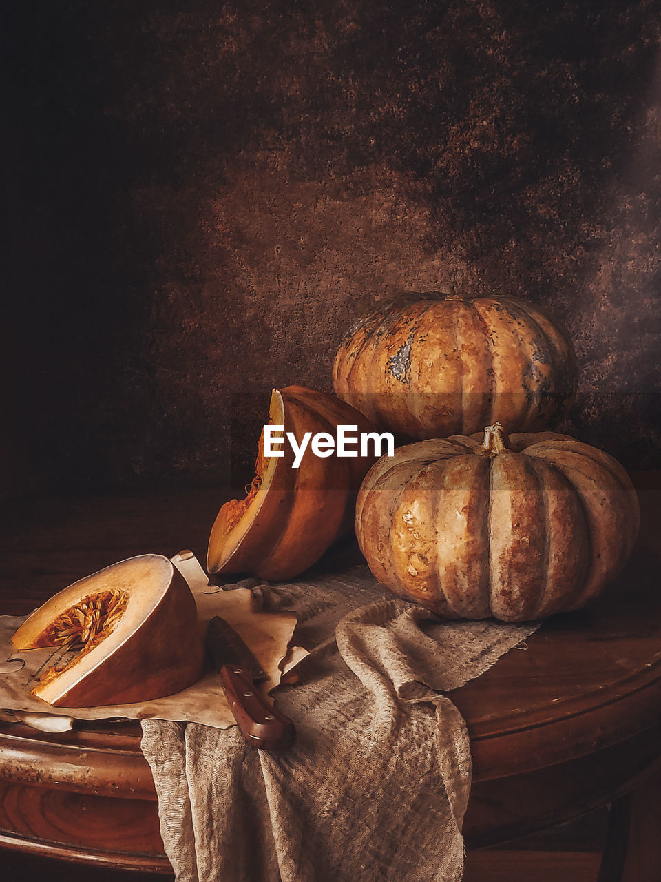 Eye level angle view of pumpkins on table