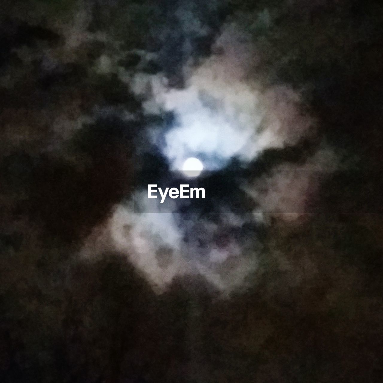 Full moon behind clouds