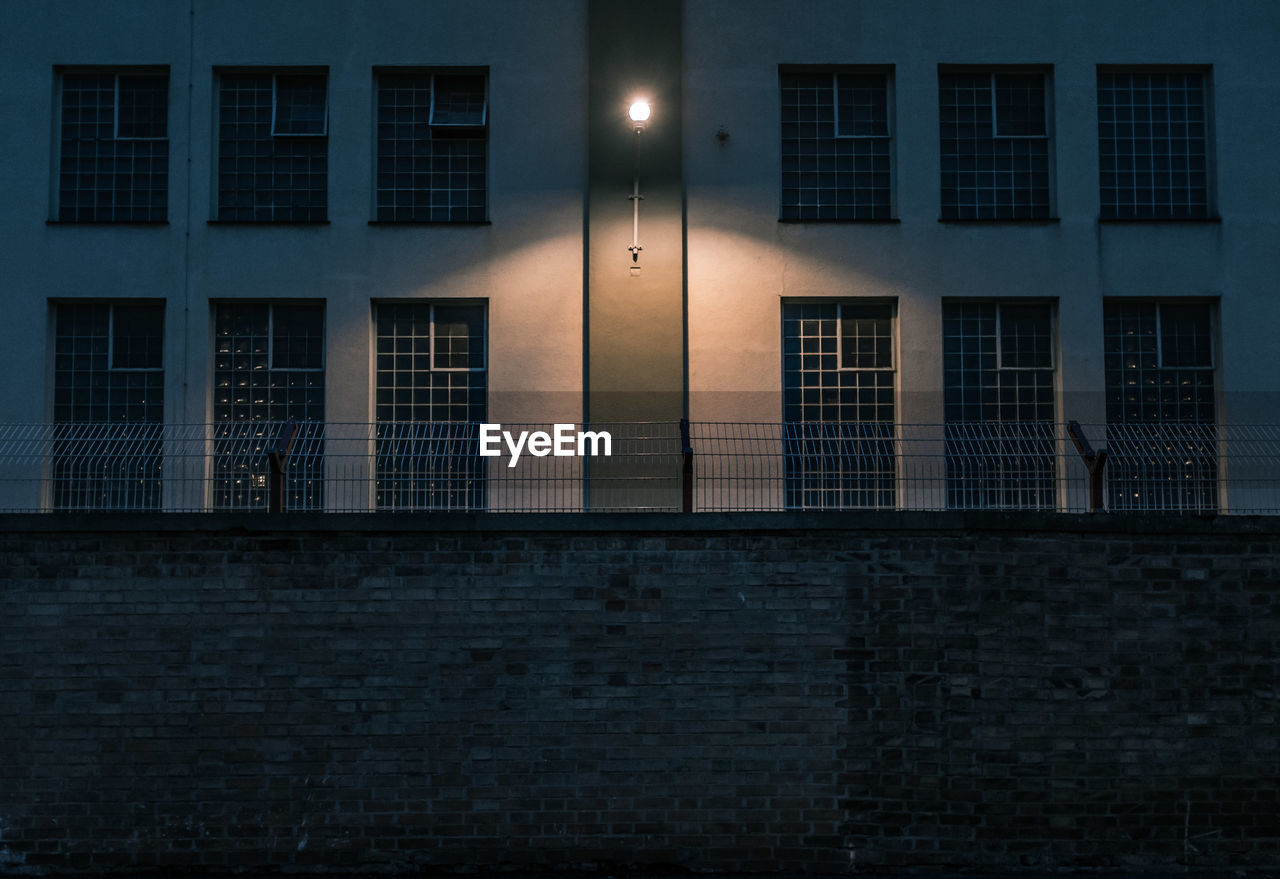 Illuminated lighting equipment mounted on prison building