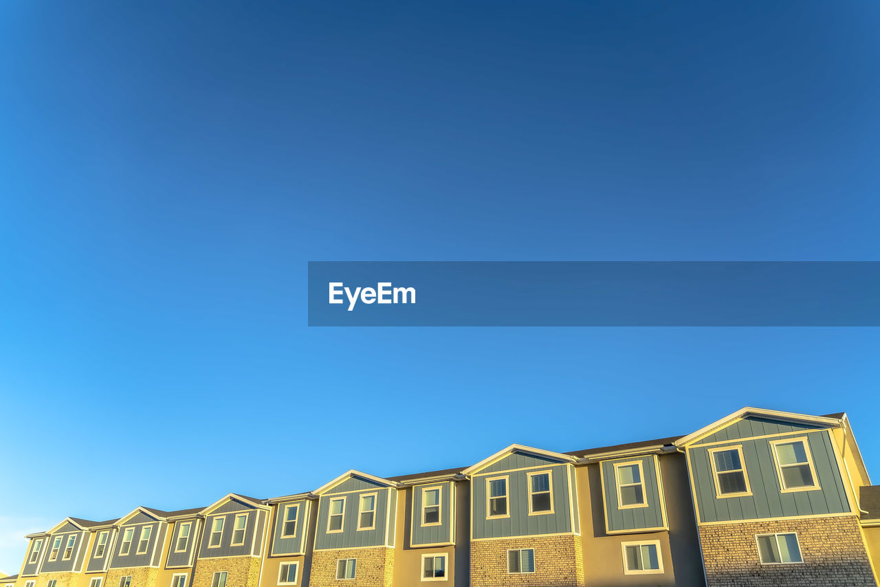 LOW ANGLE VIEW OF BUILDINGS AGAINST CLEAR SKY