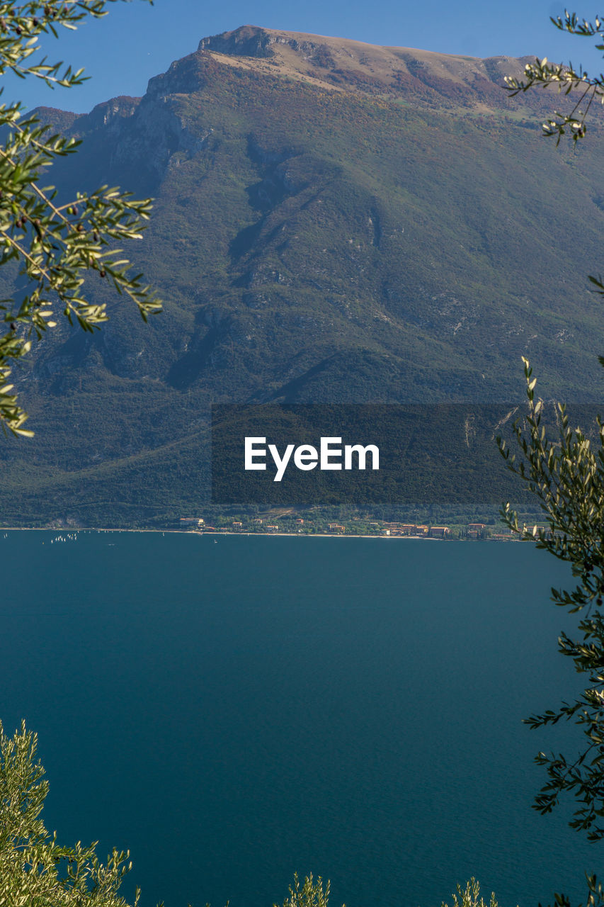 High angle view of lake and mountains against sky