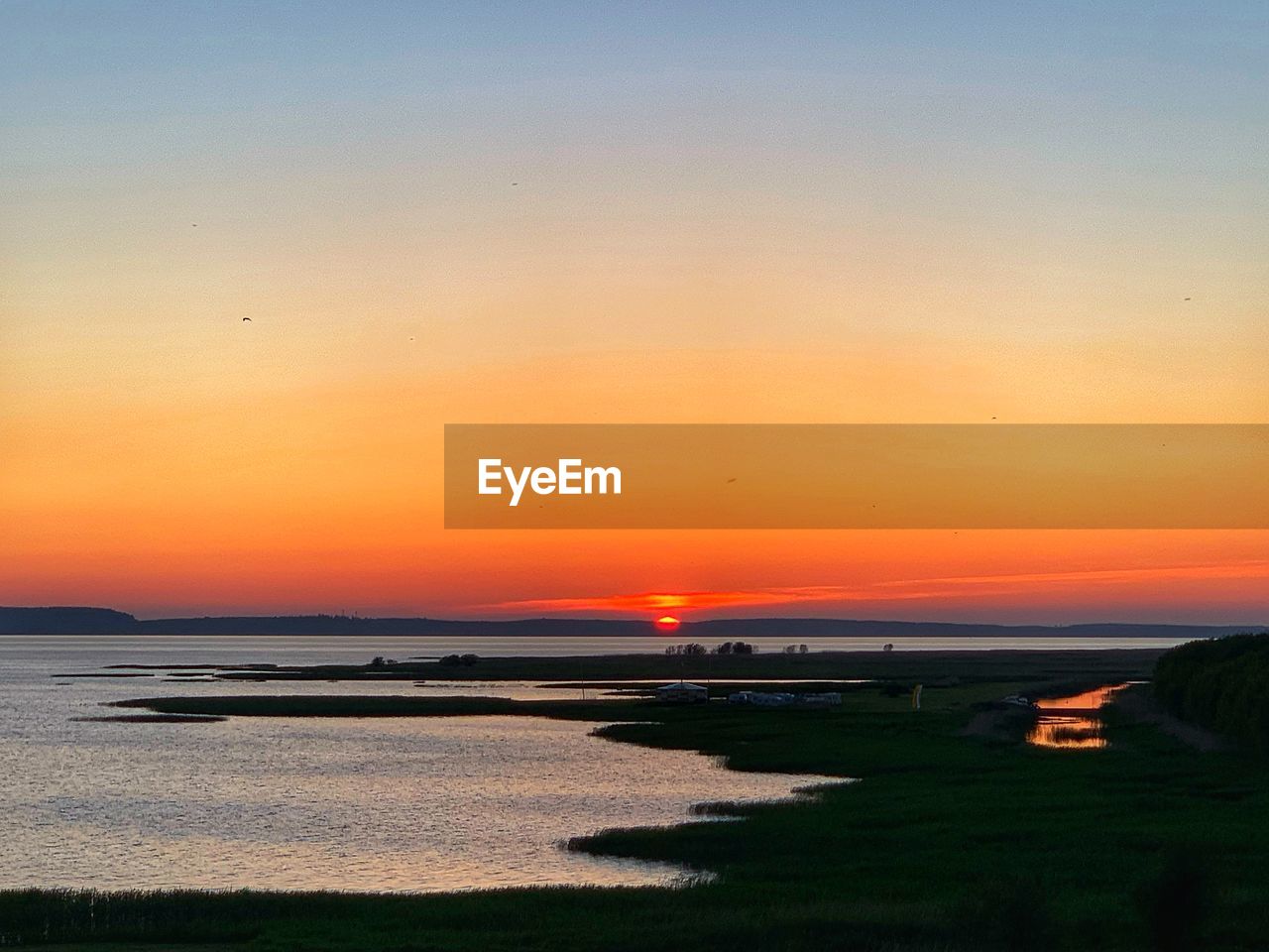 scenic view of beach against sky during sunset