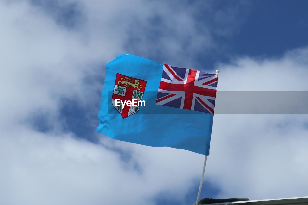 Low angle view of fijian flag against sky