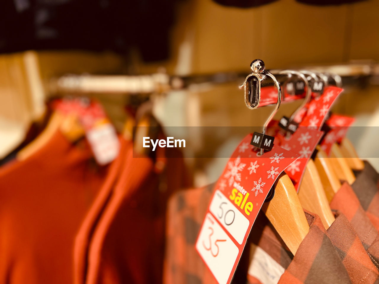 hanging, red, focus on foreground, no people, selective focus, text, close-up, retail, tradition, large group of objects, coathanger