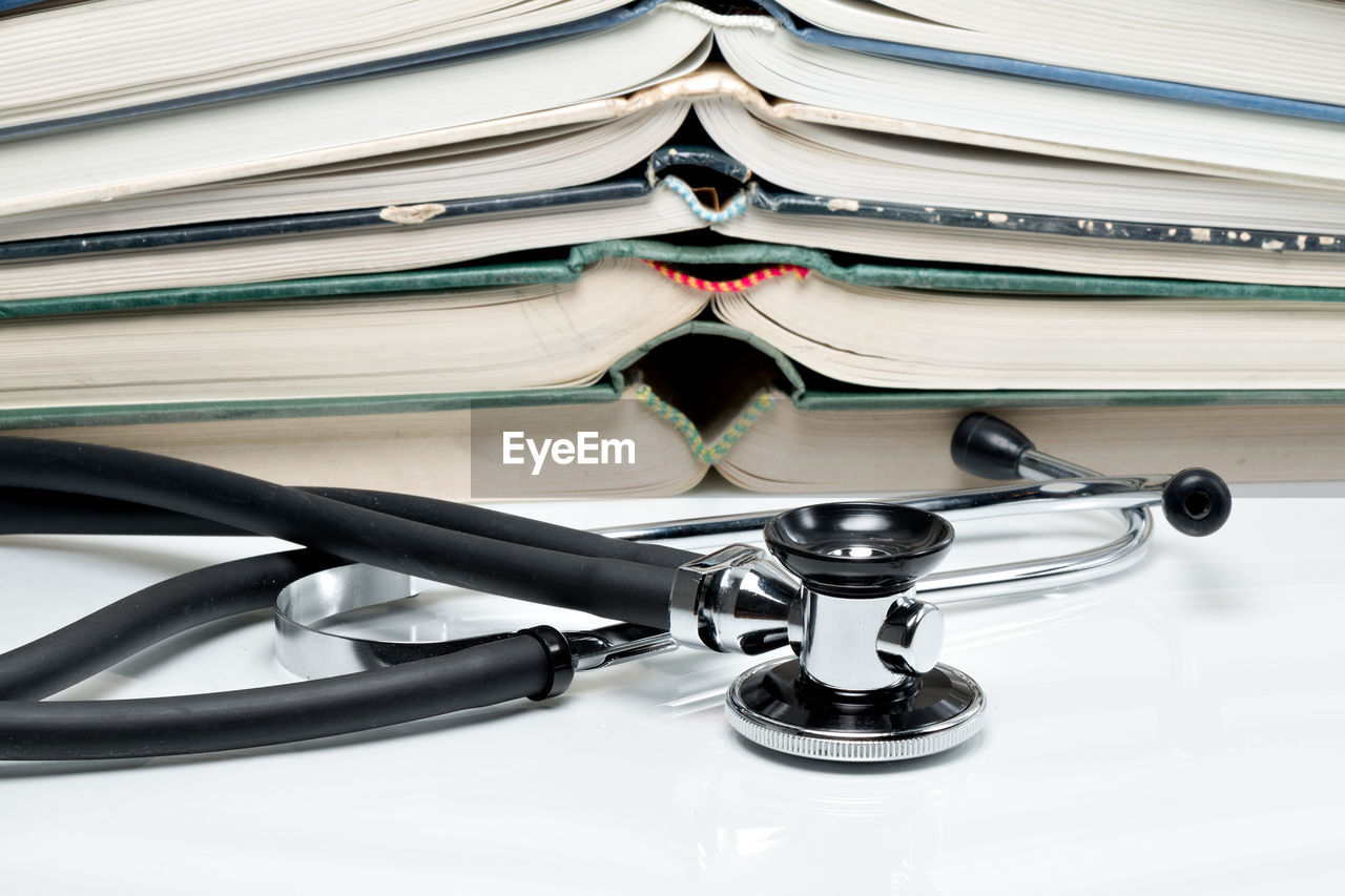 Close-up of books and stethoscope on table