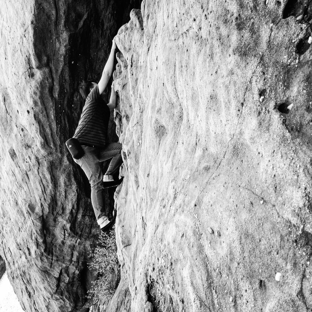 Side view of hiker climbing mountain