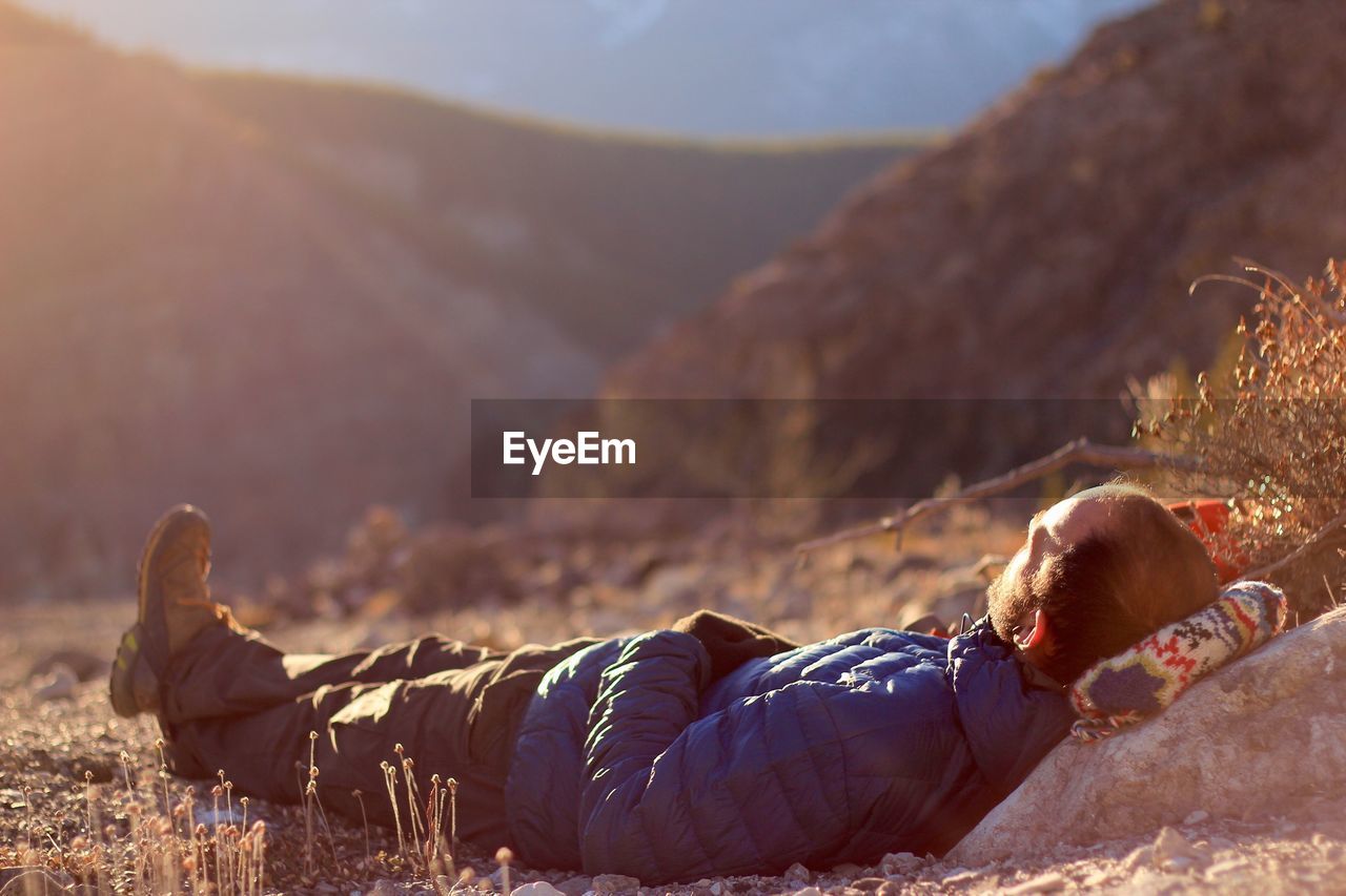 Full length of man lying on mountain