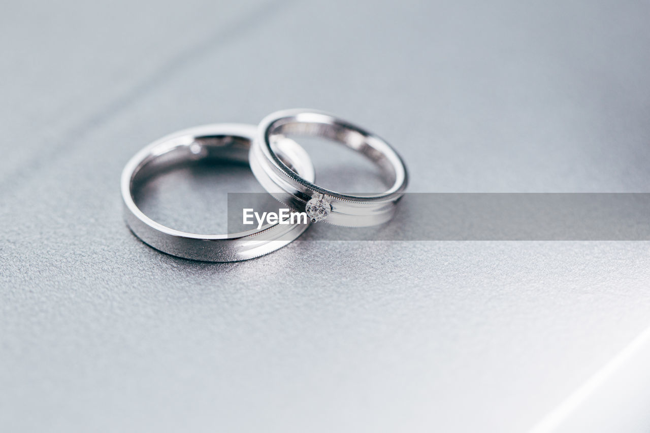 High angle view of platinum wedding rings on table