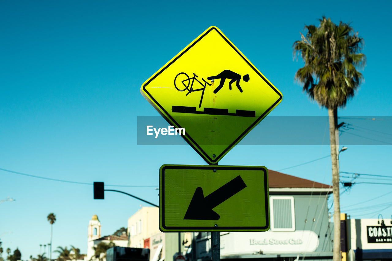 Low angle view of road sign against sky